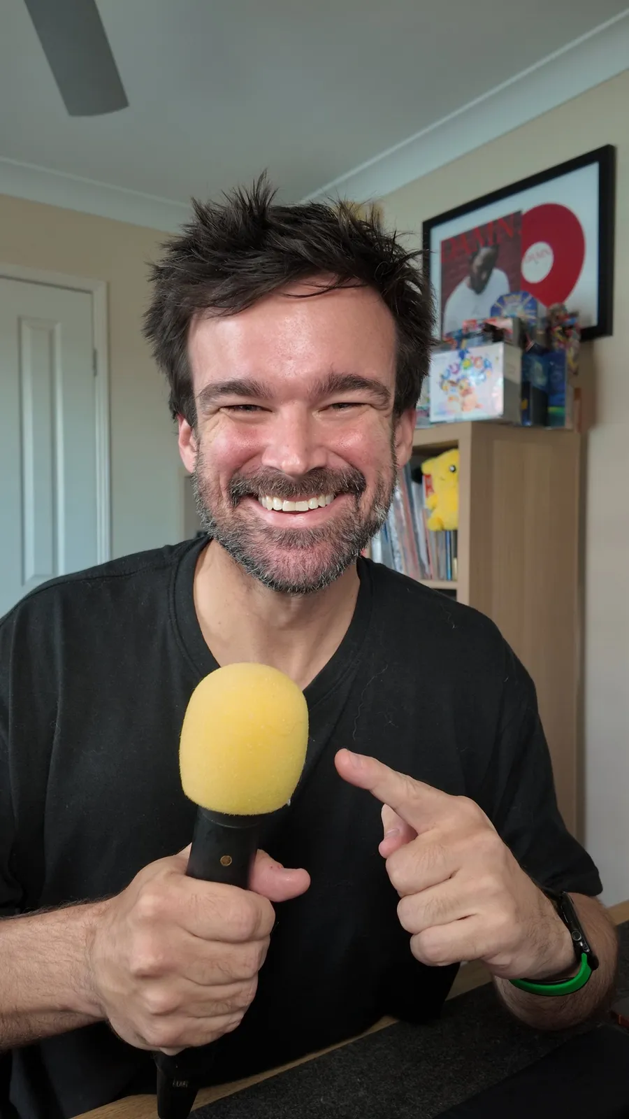 Matt Oxlade from MattSimplified holding a microphone at his desk